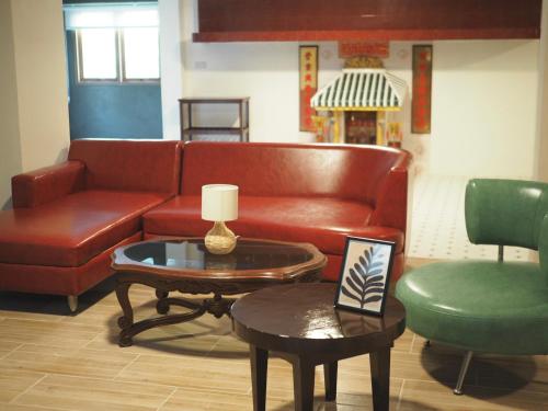a living room with a couch and a table at Krung Tone Hostel in Bangkok