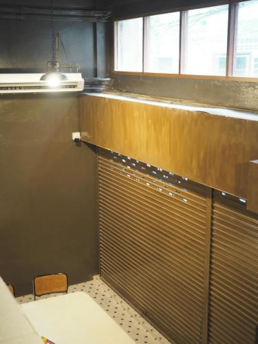 a bathroom with a metal gate in a room at Krung Tone Hostel in Bangkok
