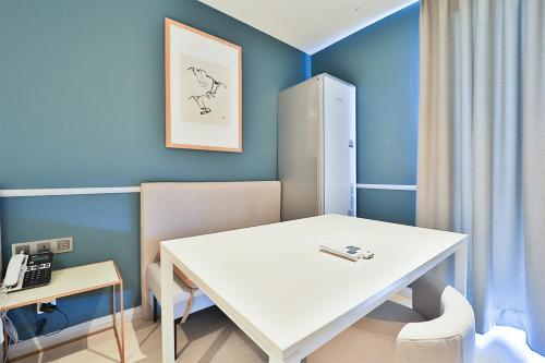 a room with a white table and a telephone at Brown Dot Hotel Ulsan Samsan in Ulsan