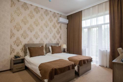 Un pat sau paturi într-o cameră la Hirkan Park Hotel