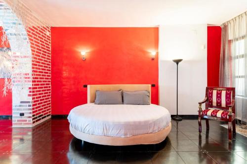 a bedroom with a bed with a red wall at Steel house in Livorno