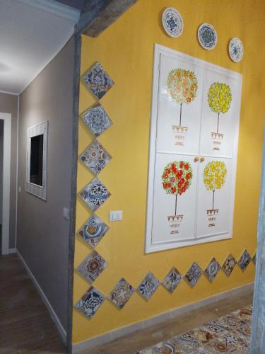 a wall with pictures of trees on it at Casuzza Bedda e Duci in Mondello