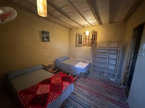 a small room with two beds and a table at Gagal camp in Siwa