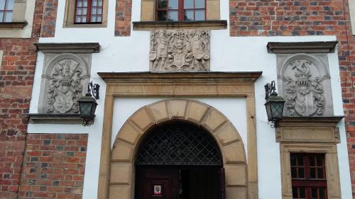 an entrance to a building with a door and windows at Zamek na wodzie w Wojnowicach in Wojnowice