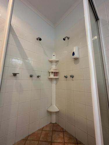 a bathroom with a shower with a glass door at Pete's Place in Berrimah