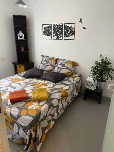 a bedroom with a bed with a colorful comforter at Parc Arena in Nîmes