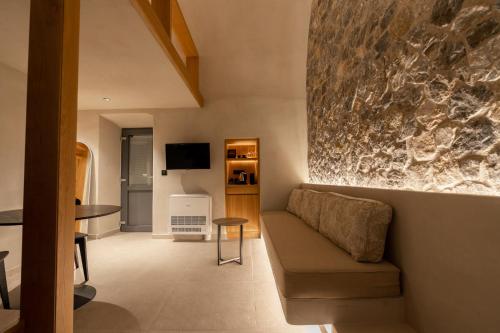 a living room with a couch and a table at Alaya Suites in Pyrgos