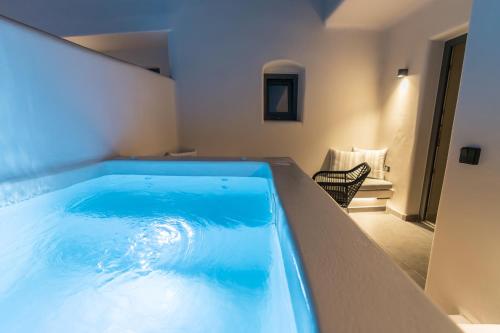 a large blue bath tub in a room at Alaya Suites in Pirgos