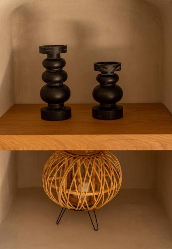 two black objects sitting on top of a wooden shelf at Alaya Suites in Pirgos