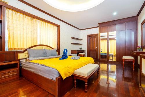 a bedroom with a bed with a blue toy on it at Orchid Pool Villa Phuket - SHA Extra Plus in Phuket Town