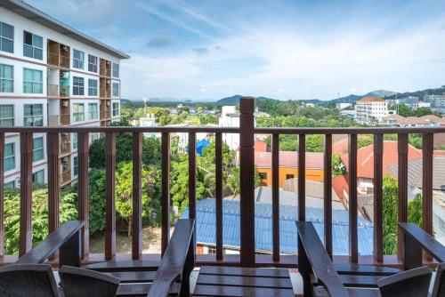 a view from the balcony of a building with chairs at Orchid Pool Villa Phuket - SHA Extra Plus in Phuket Town