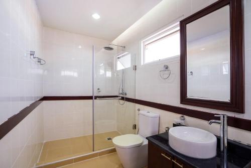 a bathroom with a toilet and a glass shower at Orchid Pool Villa Phuket - SHA Extra Plus in Phuket Town