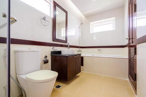 a bathroom with a toilet and a sink and a tub at Orchid Pool Villa Phuket - SHA Extra Plus in Phuket Town