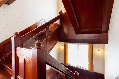 a stairway with wooden stairs and a window at Orchid Pool Villa Phuket - SHA Extra Plus in Phuket Town
