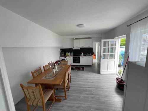 a kitchen and dining room with a table and chairs at Snoghoj,self check in,read listing in Fredericia