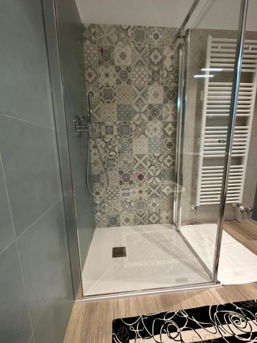 a shower with a glass door in a bathroom at Isabel's House in Arco