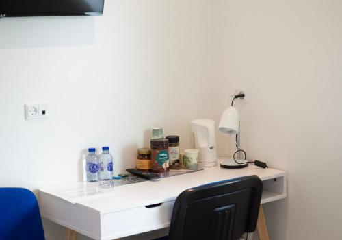 a white desk with a lamp on top of it at Gørding Bed and Breakfast in Gørding