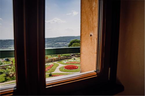 a view of a garden from a window at Villa Pellegrini in Grezzana
