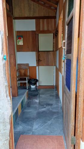 an entrance to a room with a door and a chair at Omah Kepel Yogyakarta in Soprayan