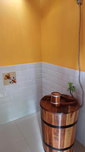 a large wooden barrel in a bathroom with a shower at Omah Kepel Yogyakarta in Soprayan