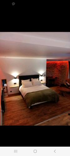 a bedroom with a large bed with two lamps at Romantique room in Charleville-Mézières