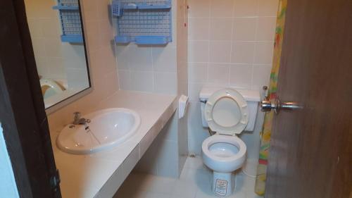 a bathroom with a toilet and a sink at Victory view rayong beach in Ban Chamrung