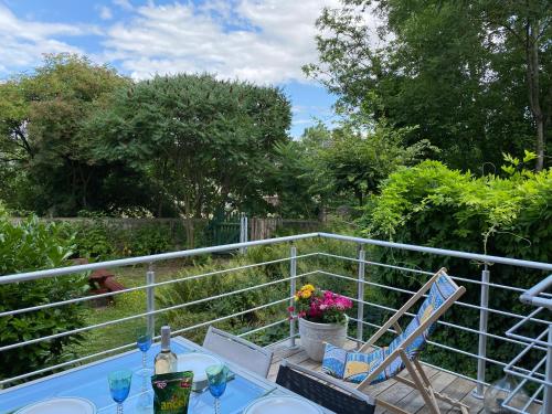 a patio with a table and a chair and flowers at Les Arches du Couvent - classé 5 étoiles in Marmoutier