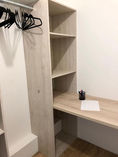 a wooden book shelf in a room at Les chambres du Roc'h Hir à Loguivy de la Mer in Ploubazlanec