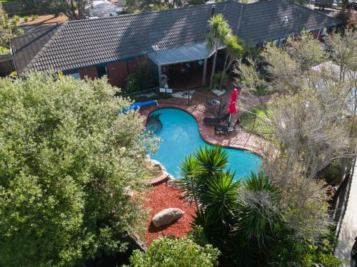 an overhead view of a swimming pool in a yard at Fun Filled Renovated 80's Gem, 400m to Beach! in Torquay