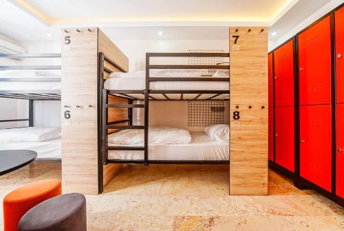 a room with two bunk beds with red cabinets at Manu Startup House in Istanbul