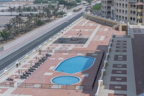 an overhead view of a swimming pool on a building at Serene Studio & Sea View & Brand New Listing in Ras al Khaimah