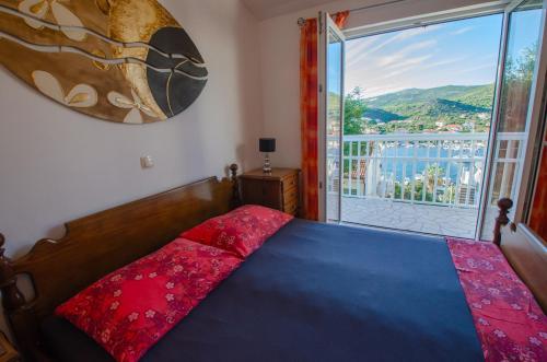 a bedroom with a bed and a large window at Villa Danijela with heated pool,jacuzzi and sauna in Seget Vranjica
