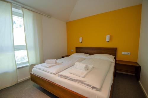 a bedroom with a bed with white towels on it at Finest Apartments Glacier View by All in One Apartments in Kaprun