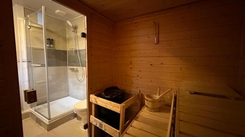 a wooden bathroom with a shower and a toilet at Studio with sauna in Amsterdam