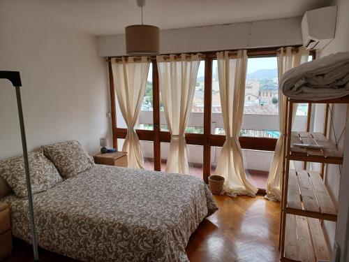 a bedroom with a bed and a large window at chambre double proche stade VELODROME in Marseille