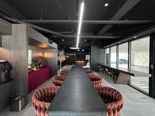 a conference room with a long table and chairs at Hotel 24st Prestige in Seosan