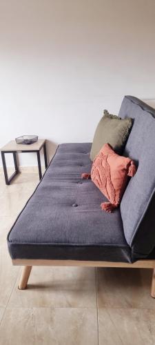 a blue bed with two pillows on top of it at Estudio en Villalonga in Pontevedra