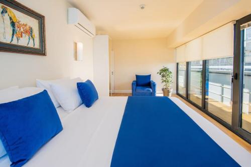 a bedroom with a large bed with blue pillows at Orbi hotel sea view in Kuwait