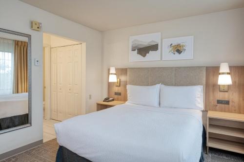 a large white bed in a hotel room at Staybridge Suites Allentown Airport Lehigh Valley by IHG in Allentown