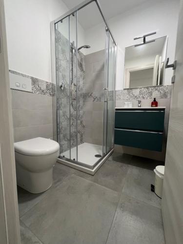 a bathroom with a shower and a toilet and a sink at San Rocco 30 - camera in campagna - Piombino in Piombino
