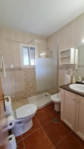 a bathroom with a shower and a toilet and a sink at Vaca House in El Puerto de Santa María