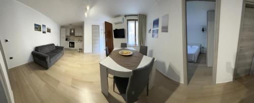 a kitchen and living room with a table and a couch at La casa di Giulia in Apricena