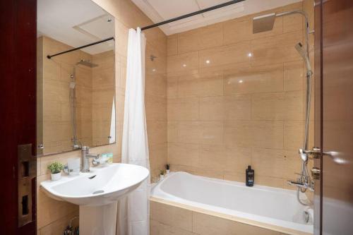 a bathroom with a sink and a bath tub and a sink at Budget Friendly & Studio & Golf View in Ras al Khaimah
