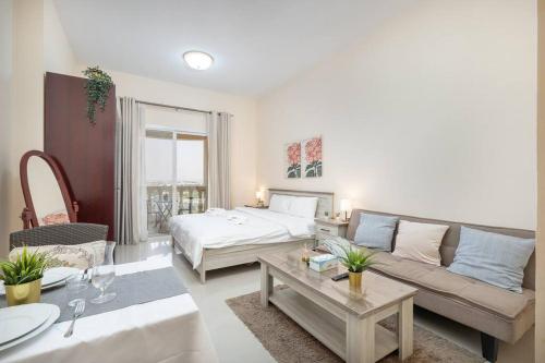 a living room with a bed and a couch at Budget Friendly & Studio & Golf View in Ras al Khaimah