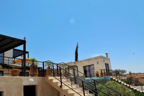 a building with stairs leading up to a house at Villa Sarah in Sidi Kouaki