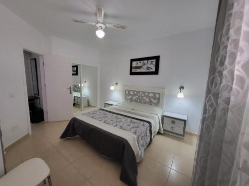 a bedroom with a bed and a ceiling fan at Magical Sunset in Adeje