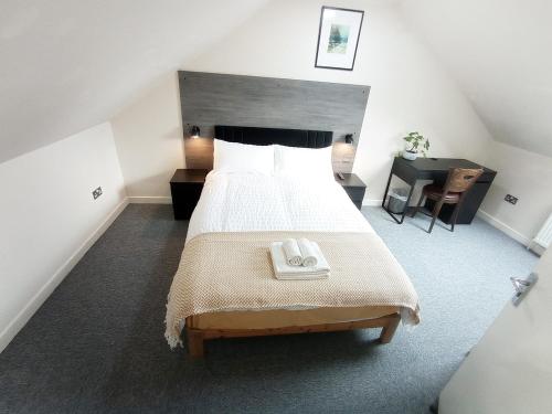 a bedroom with a large bed and a desk at Osney Cypress Studio - Self Contained Studio Flat in Oxford