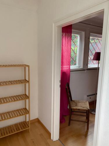 a door to a room with a chair and a window at 1 - 2 Zimmer in historischem Altstadthaus in Freudenstadt