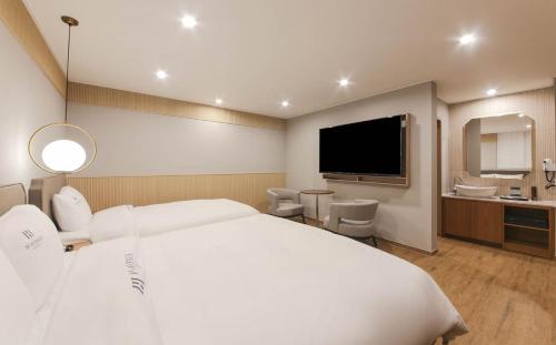 H Avenue Hotel tesisinde bir odada yatak veya yataklar