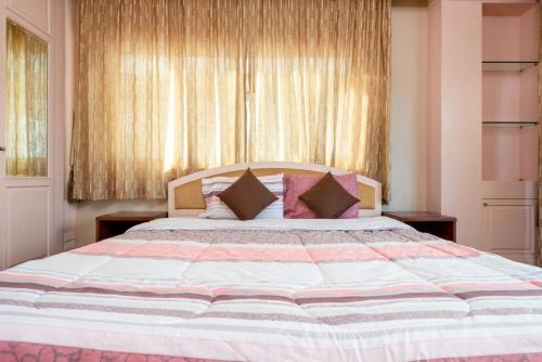 a bedroom with a large bed with pillows at Orchid Pool Villa Phuket - SHA Extra Plus in Phuket Town